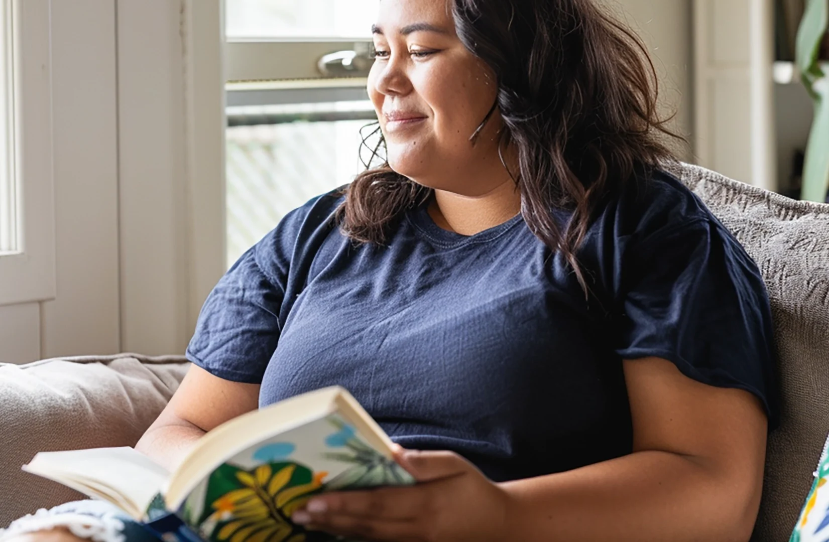 Woman reading a book and smiling